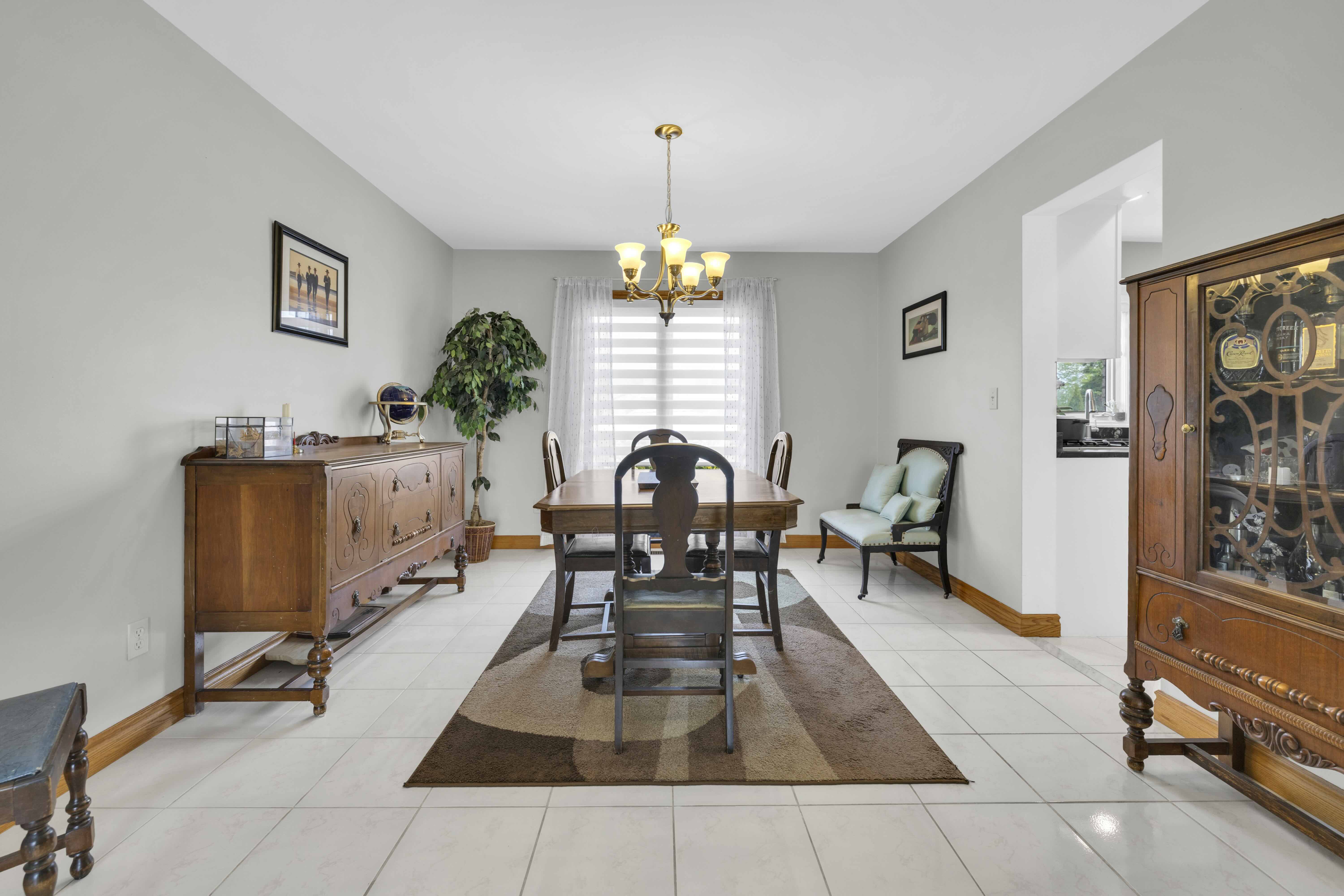 Dining room with chandelier and wooden furniture