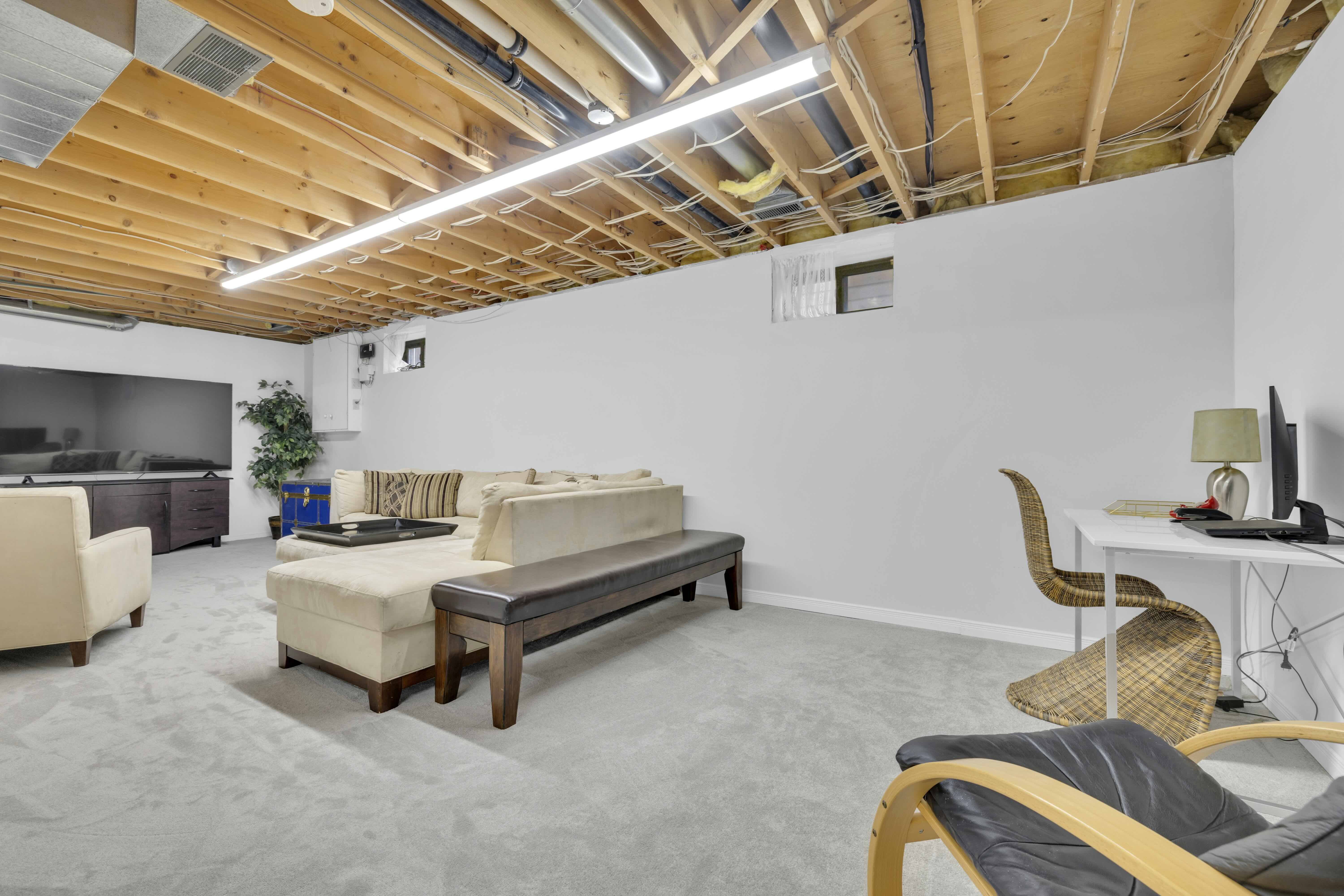 Basement lounge with sectional sofa and TV