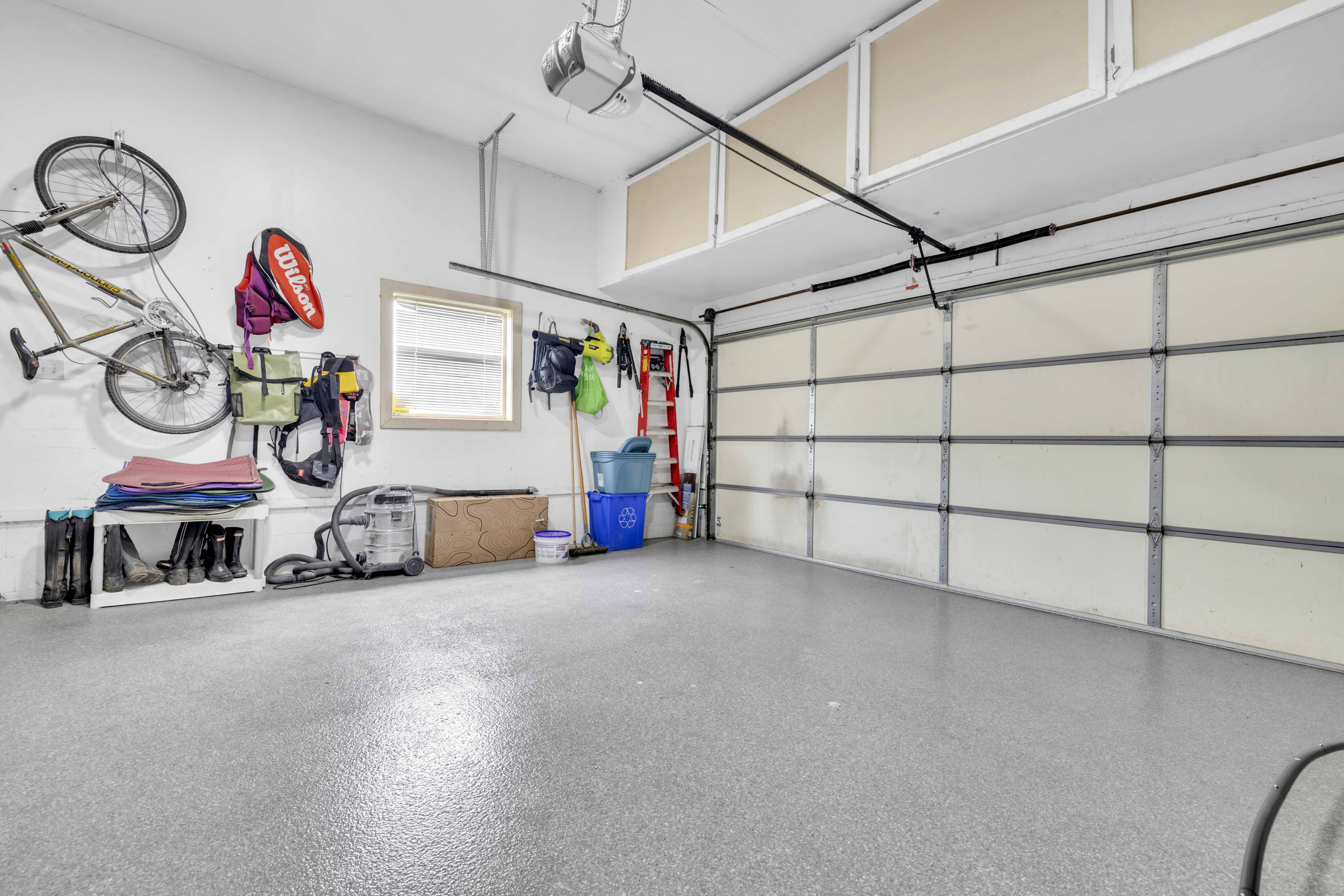 Double garage with epoxy floor, sectional door and storage
