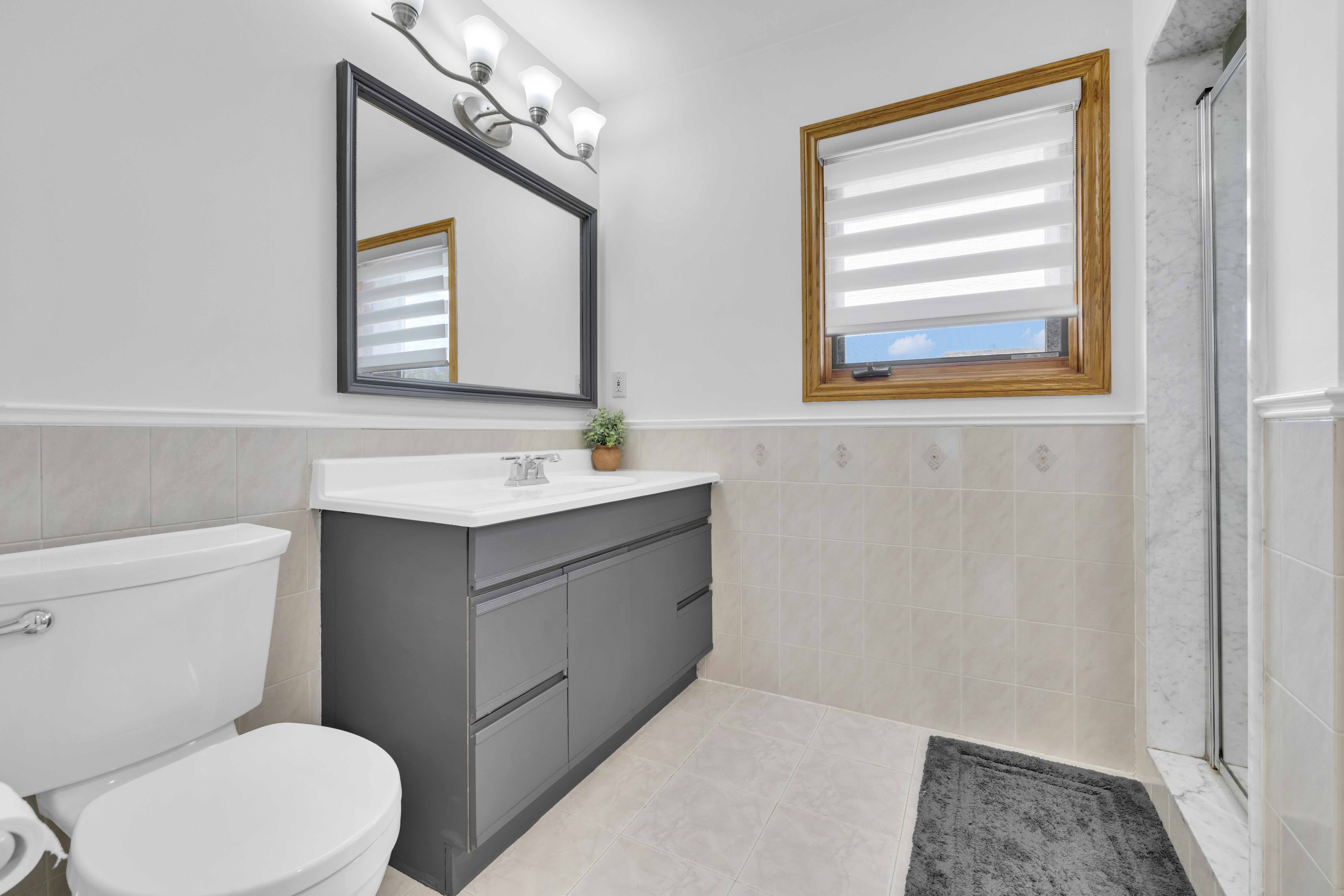 Ensuite bathroom with dark vanity and glass shower