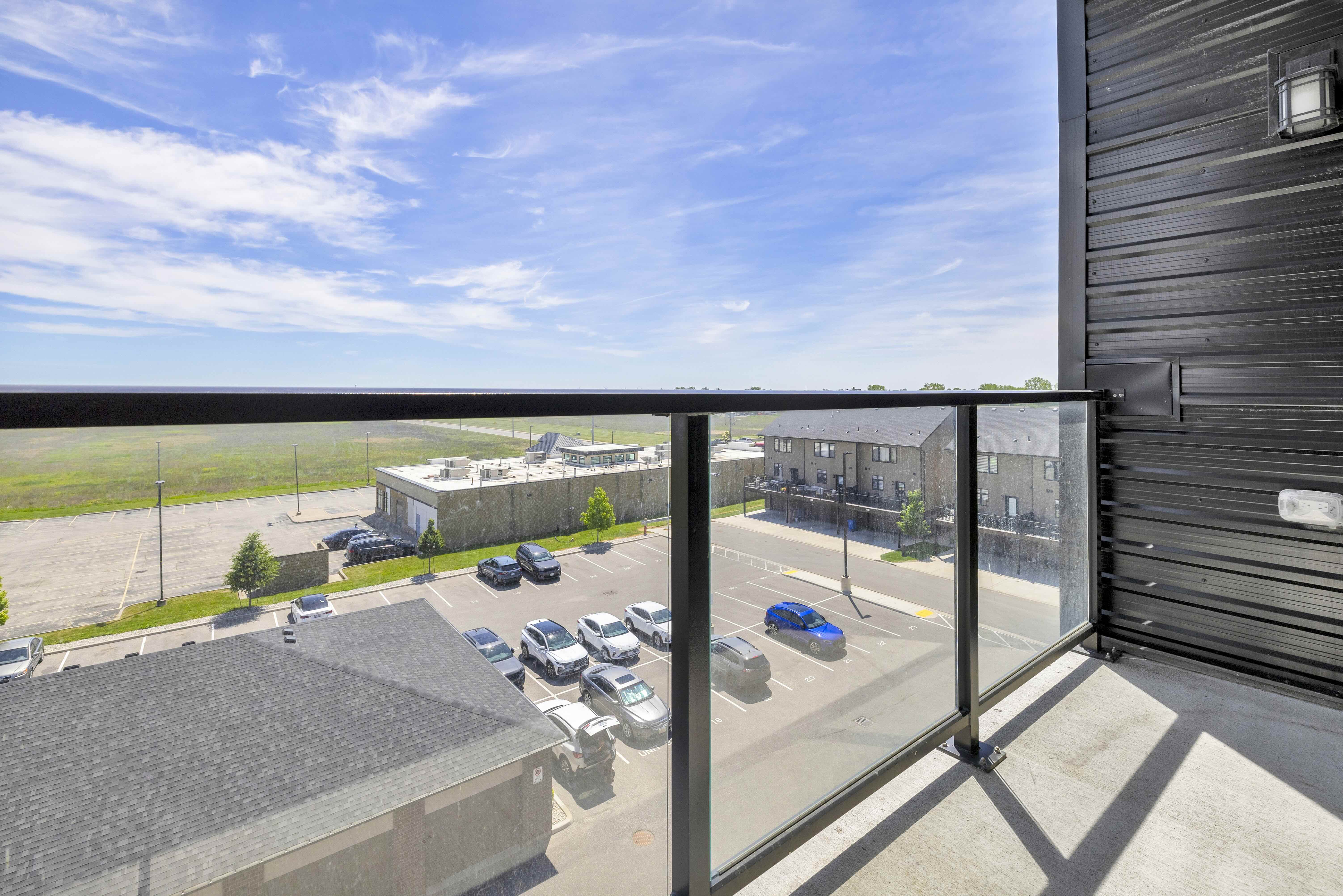 Balcony view east showing open sky and surrounding buildings