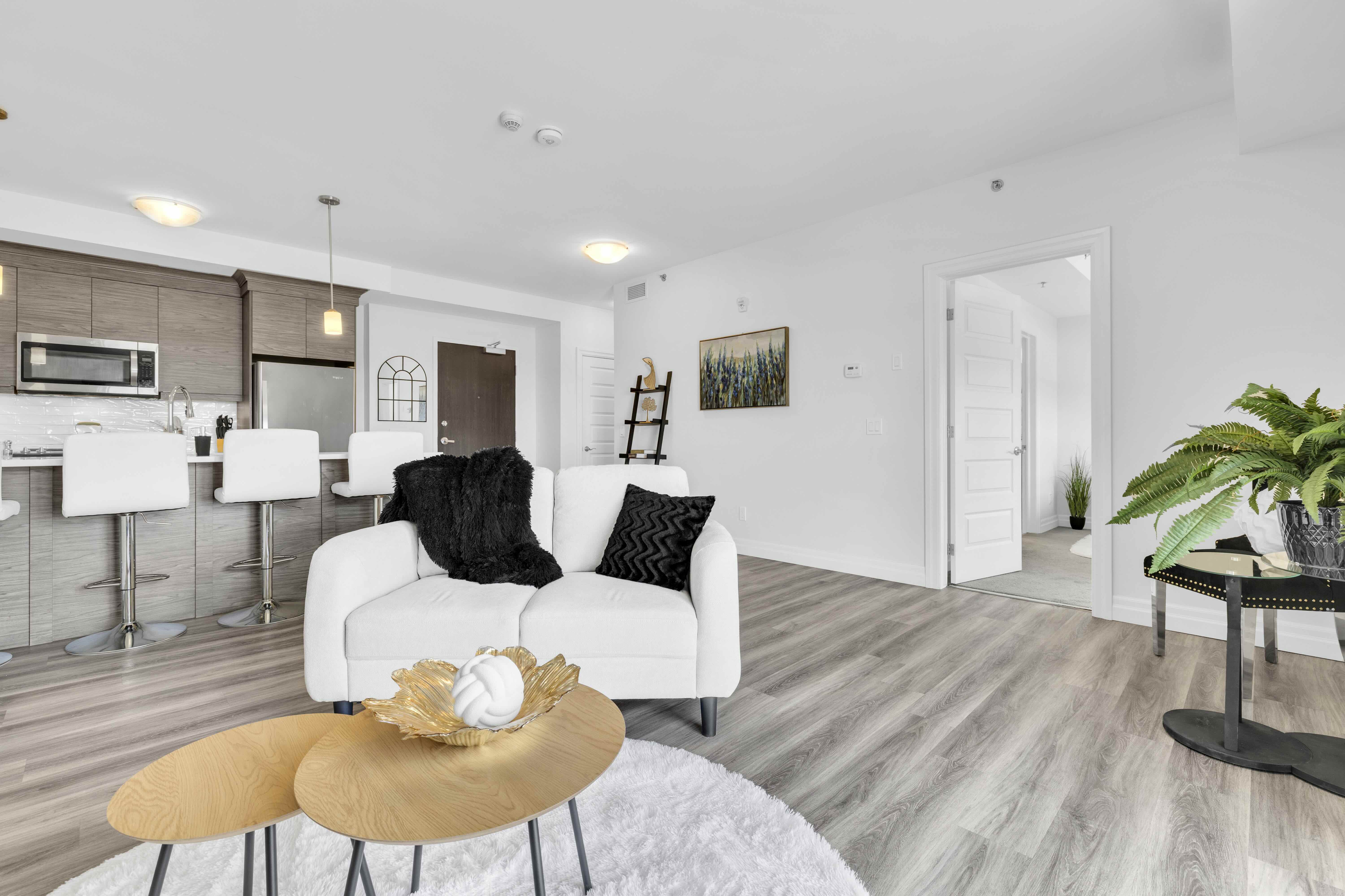 Open concept living room with kitchen visible in background