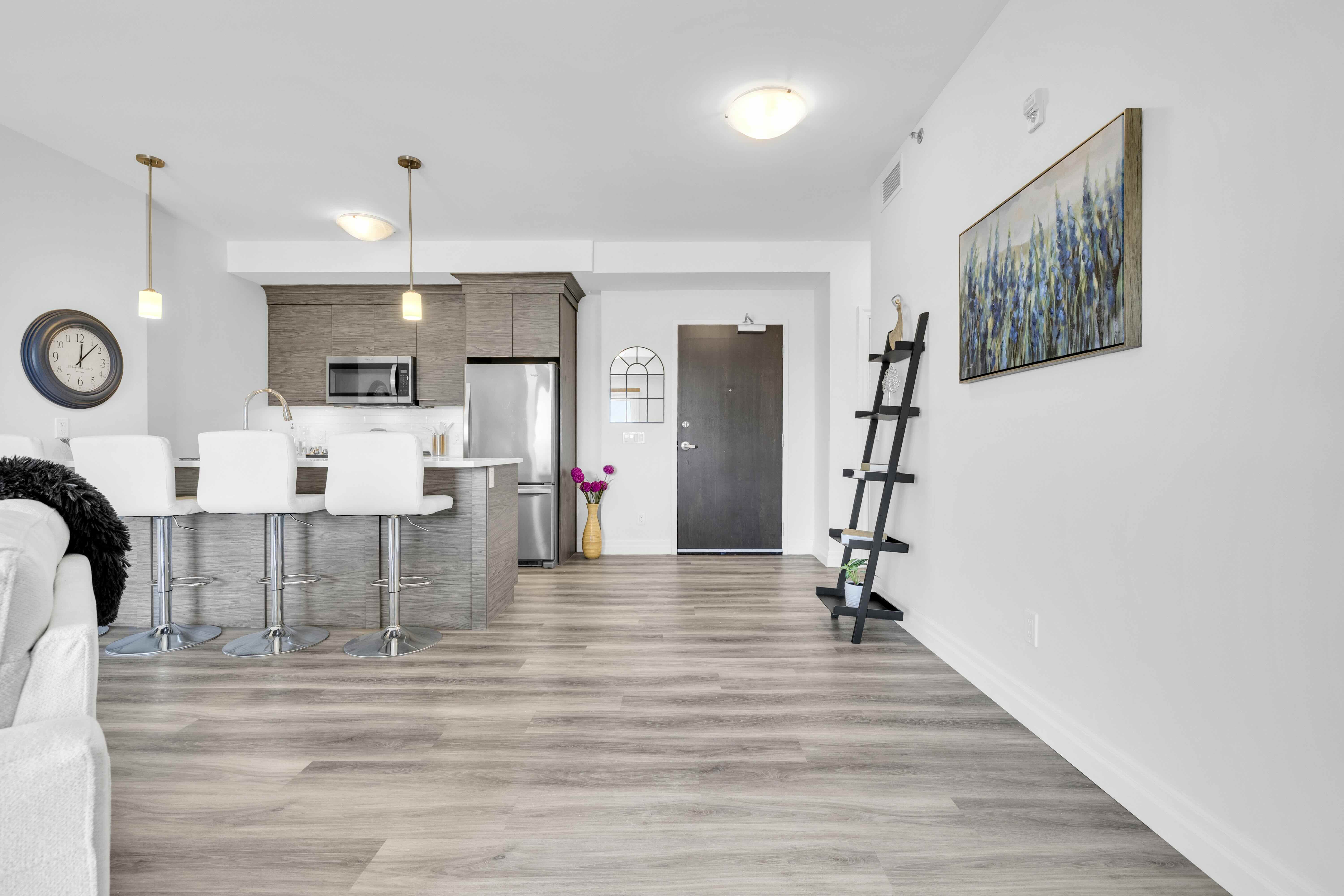 View from living area toward kitchen and main entrance