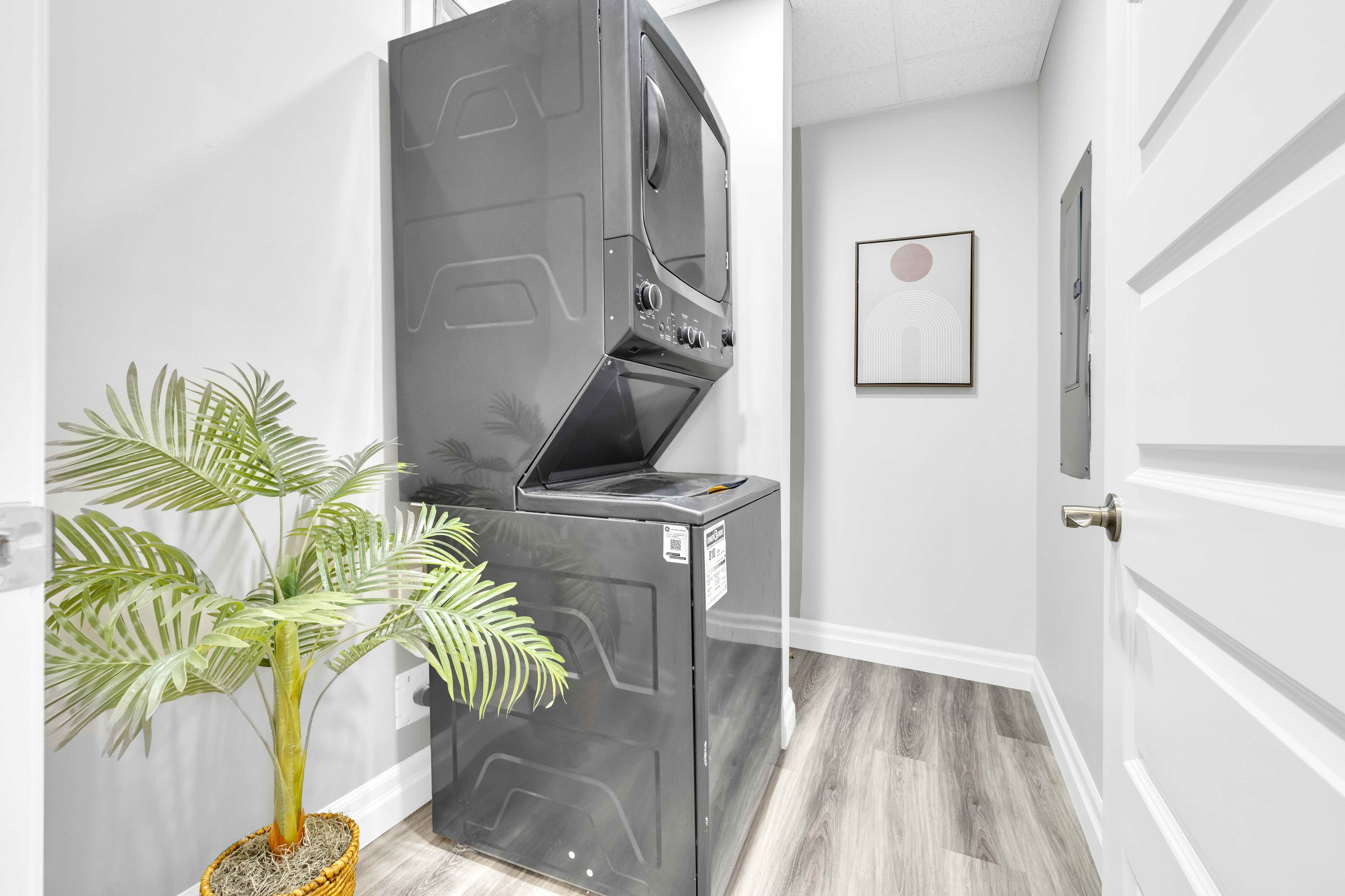 Laundry room with stacked washer and dryer
