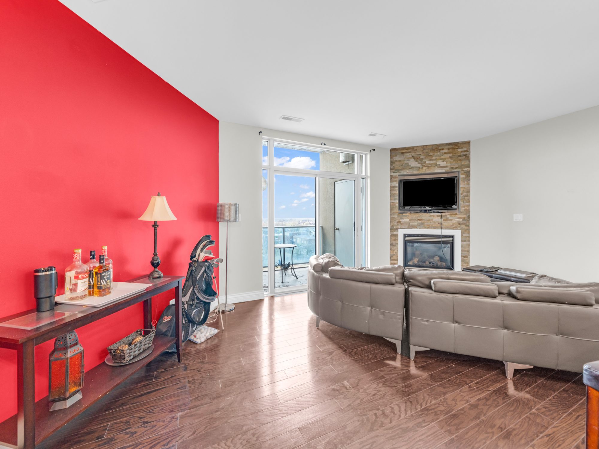 Living room red accent wall and balcony view