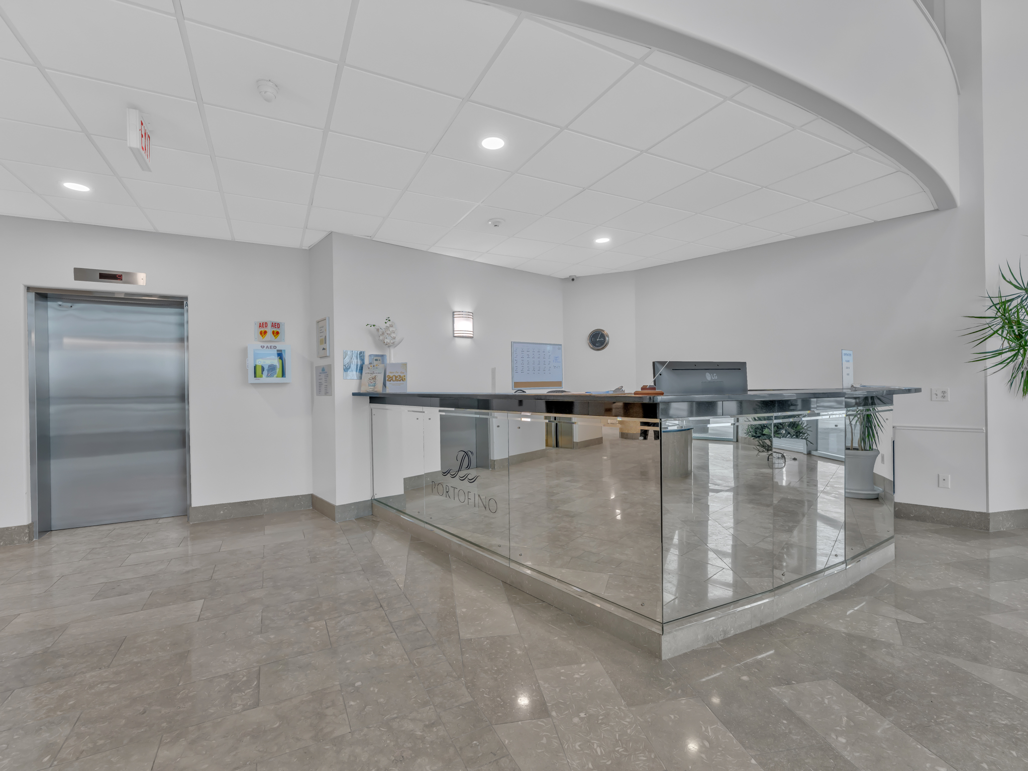 Concierge reception area with glass panels and elevator