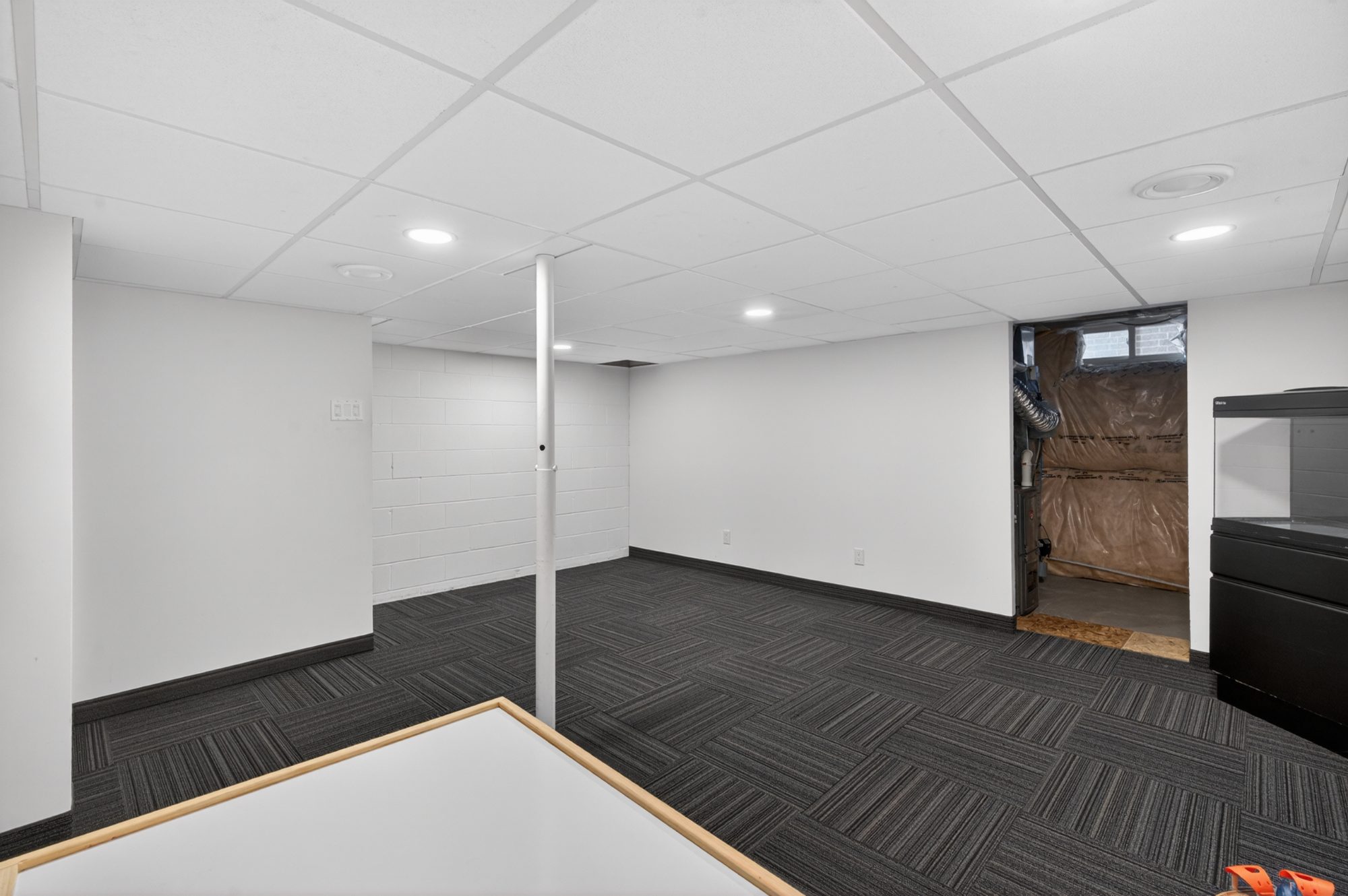 Basement open space with white walls and recessed lighting