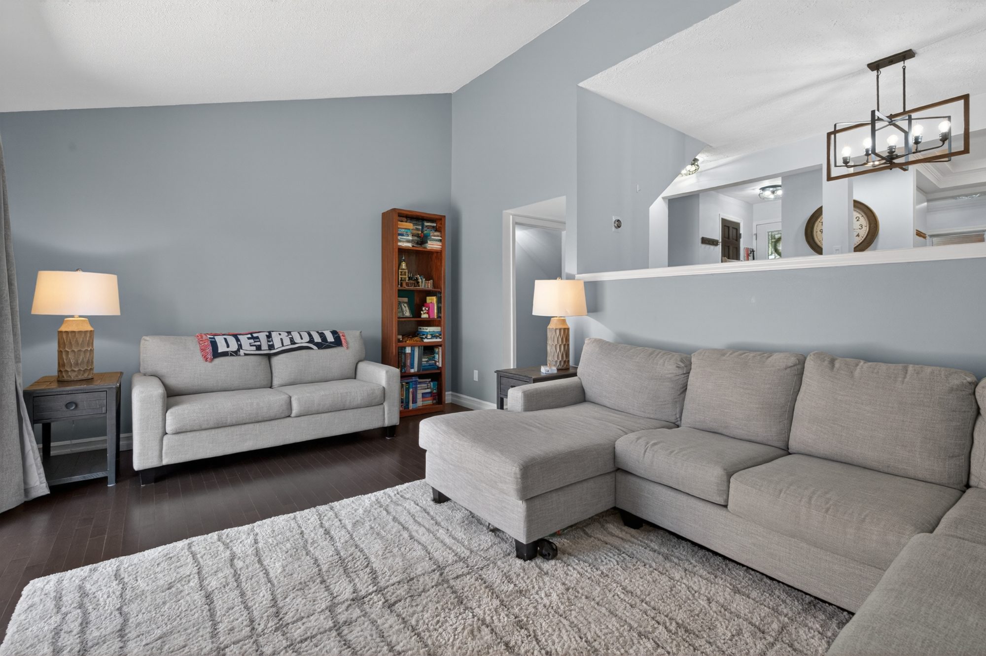 Living room showing high ceiling and half wall