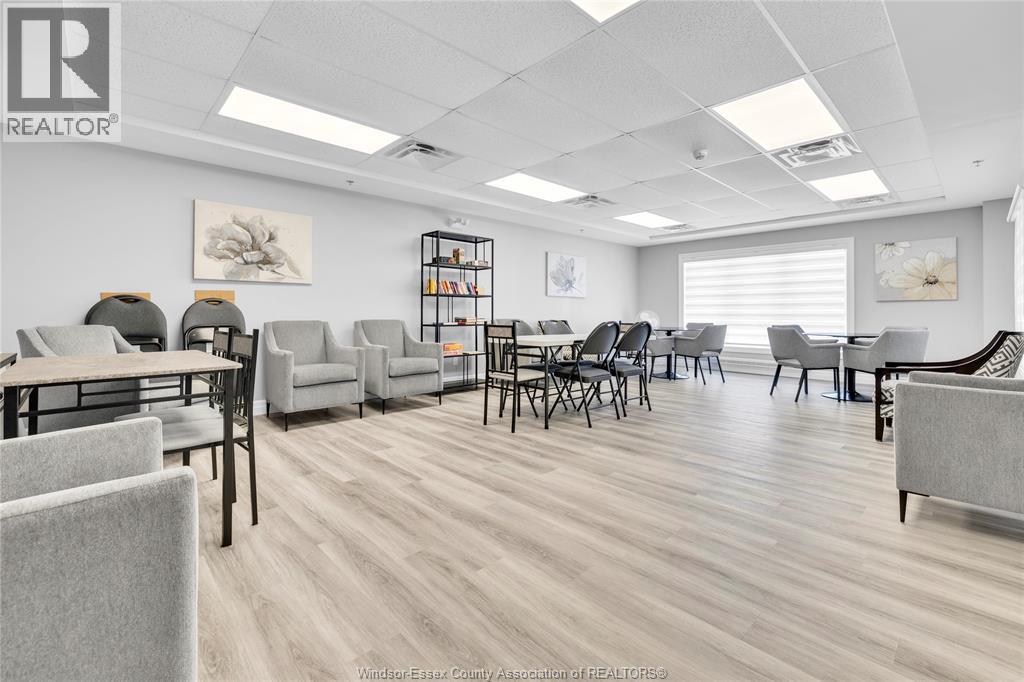 Community room with seating, tables, and large window