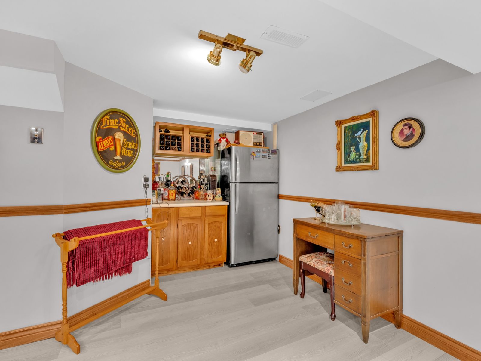The bar area with a wine rack and stainless fridge.