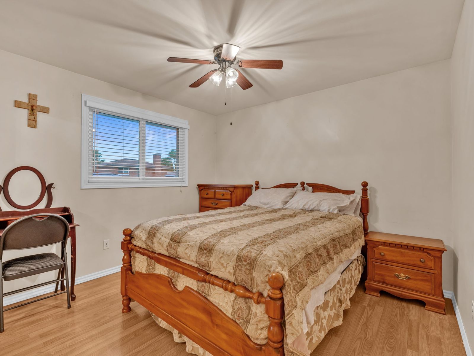 The third bedroom with a wood bed, dresser and vanity.