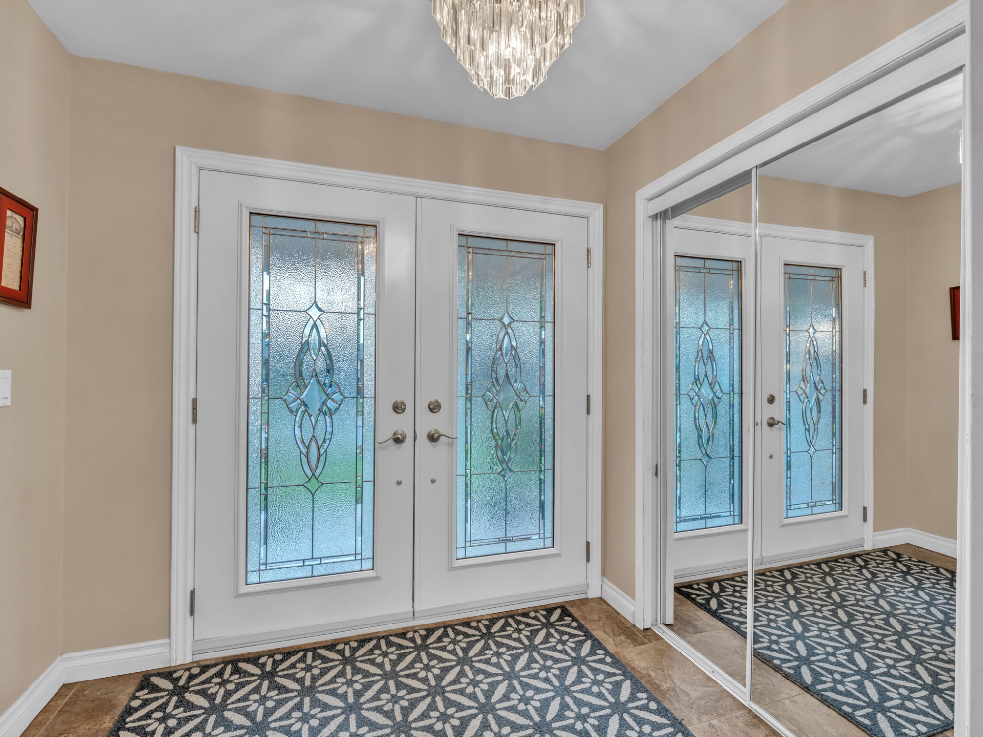 The foyer: double frosted-glass doors and mirrored closets.