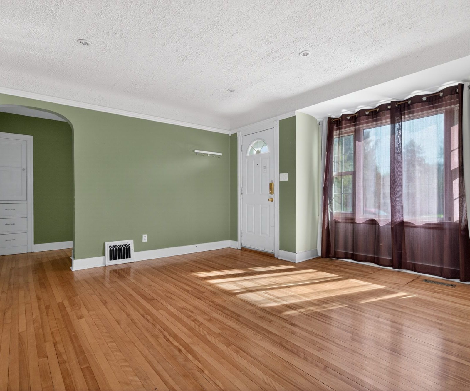 Living room with hardwood floor and built-in white cabinet
