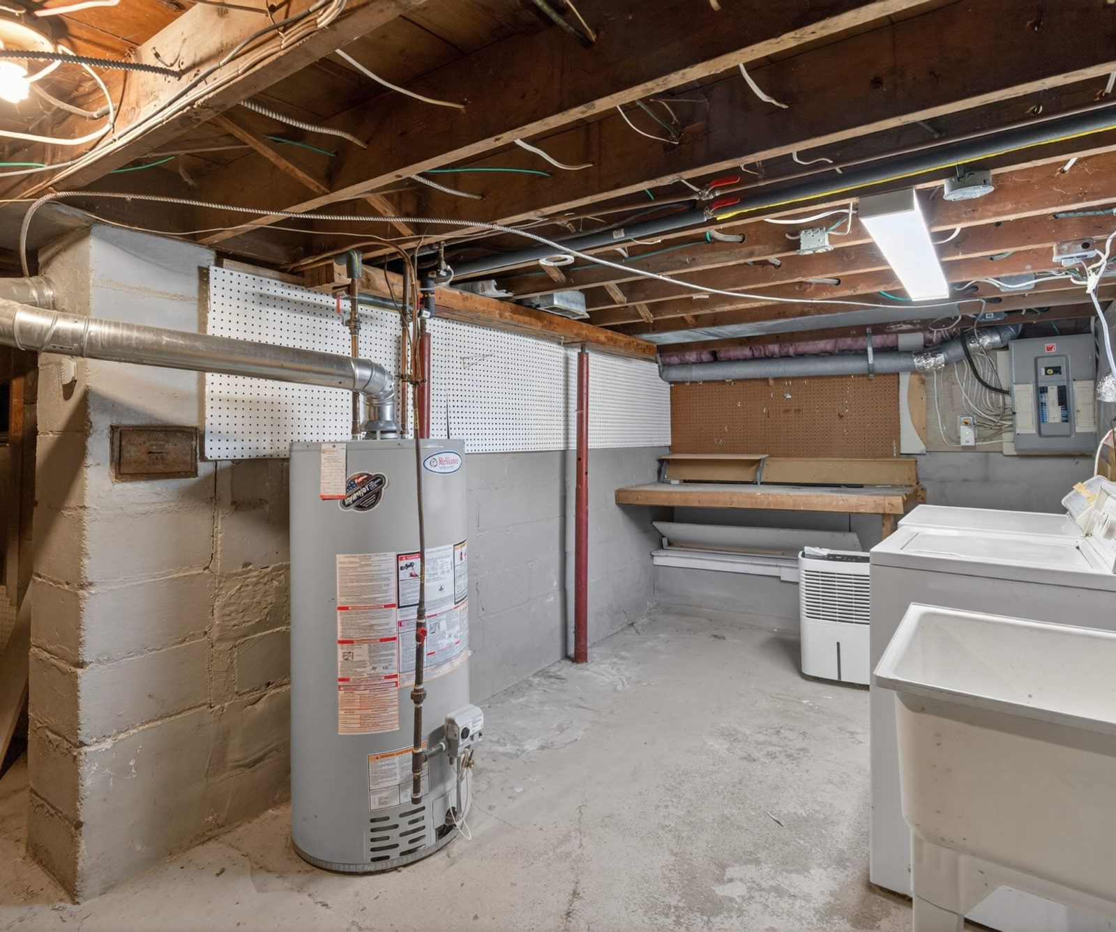 Basement with workbench, shelving, and pegboard