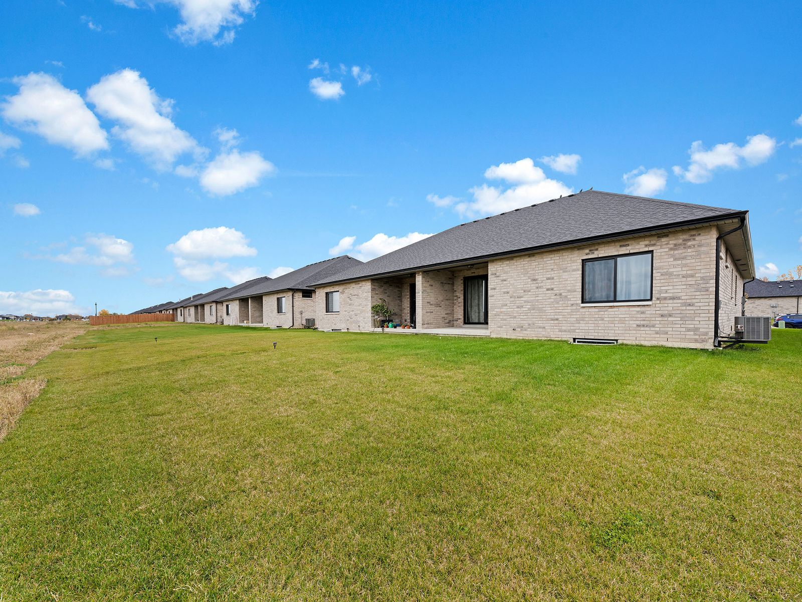 Rear exterior with covered porch and lawn