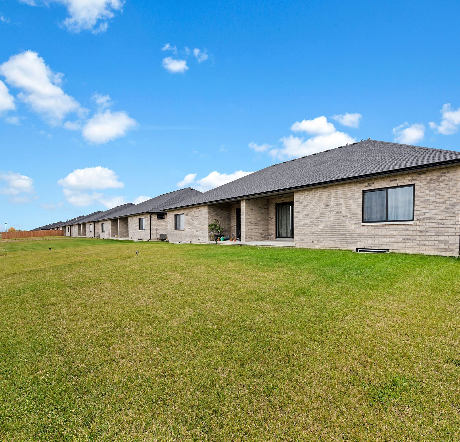 Rear exterior with covered porch and lawn