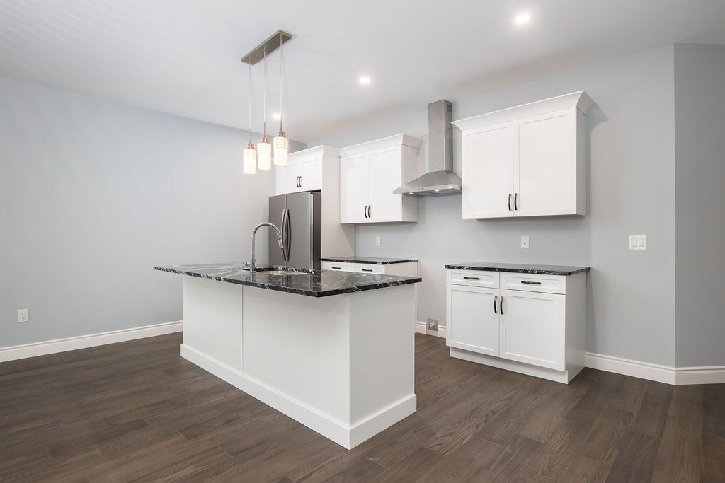 Kitchen from alternate angle showing full cabinetry run