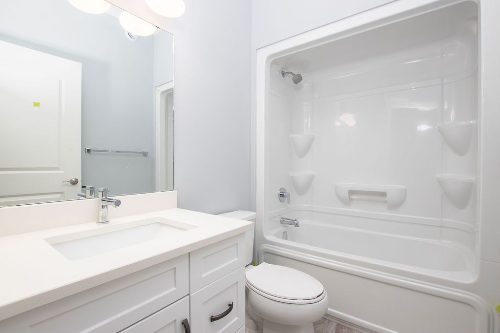 Bathroom with white vanity, bathtub and shower