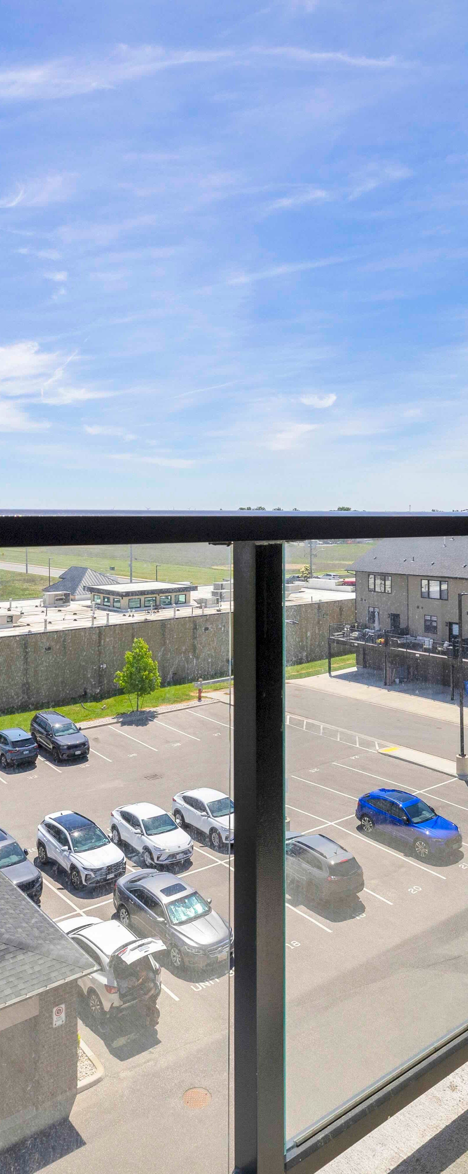 Balcony view east showing open sky and surrounding buildings