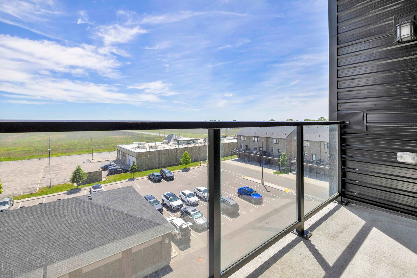 Balcony view east showing open sky and surrounding buildings