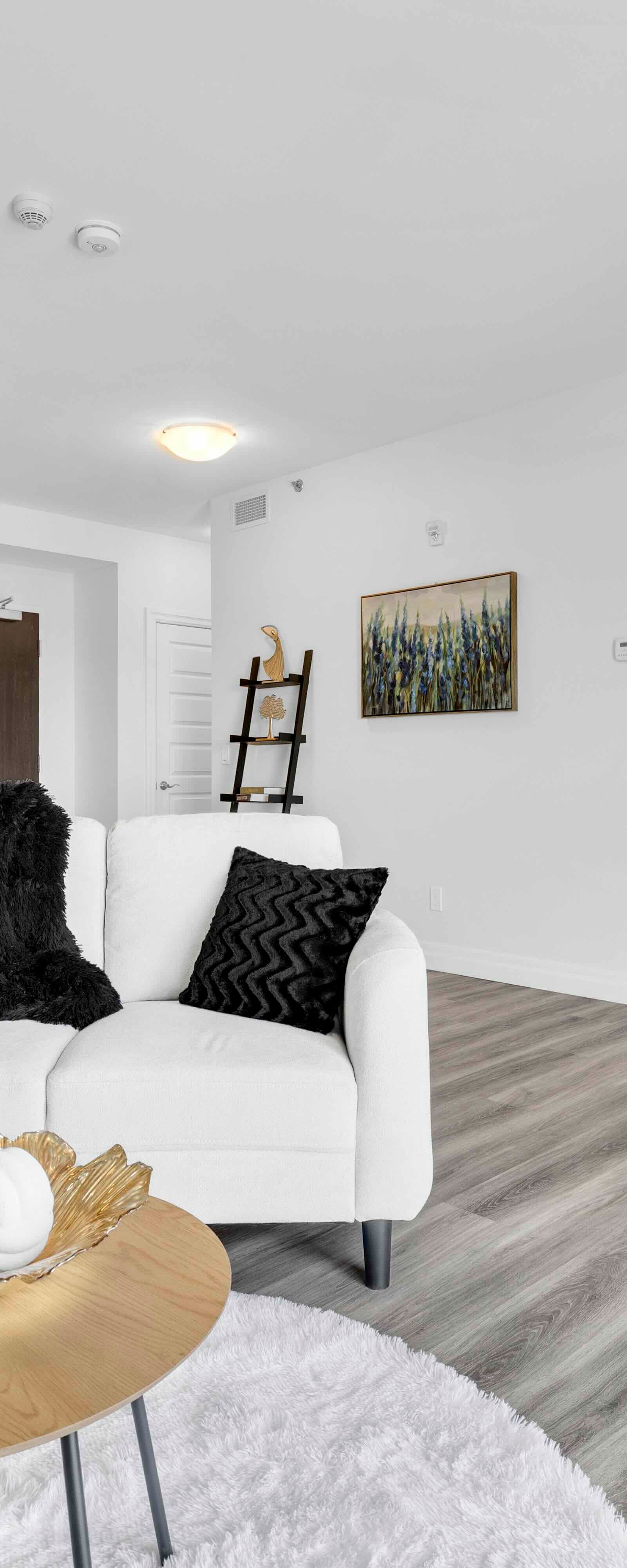 Open concept living room with kitchen visible in background