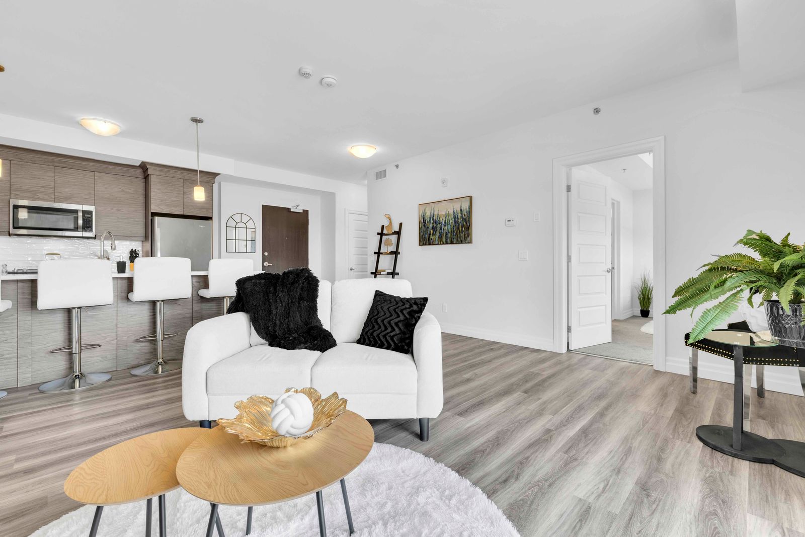Open concept living room with kitchen visible in background