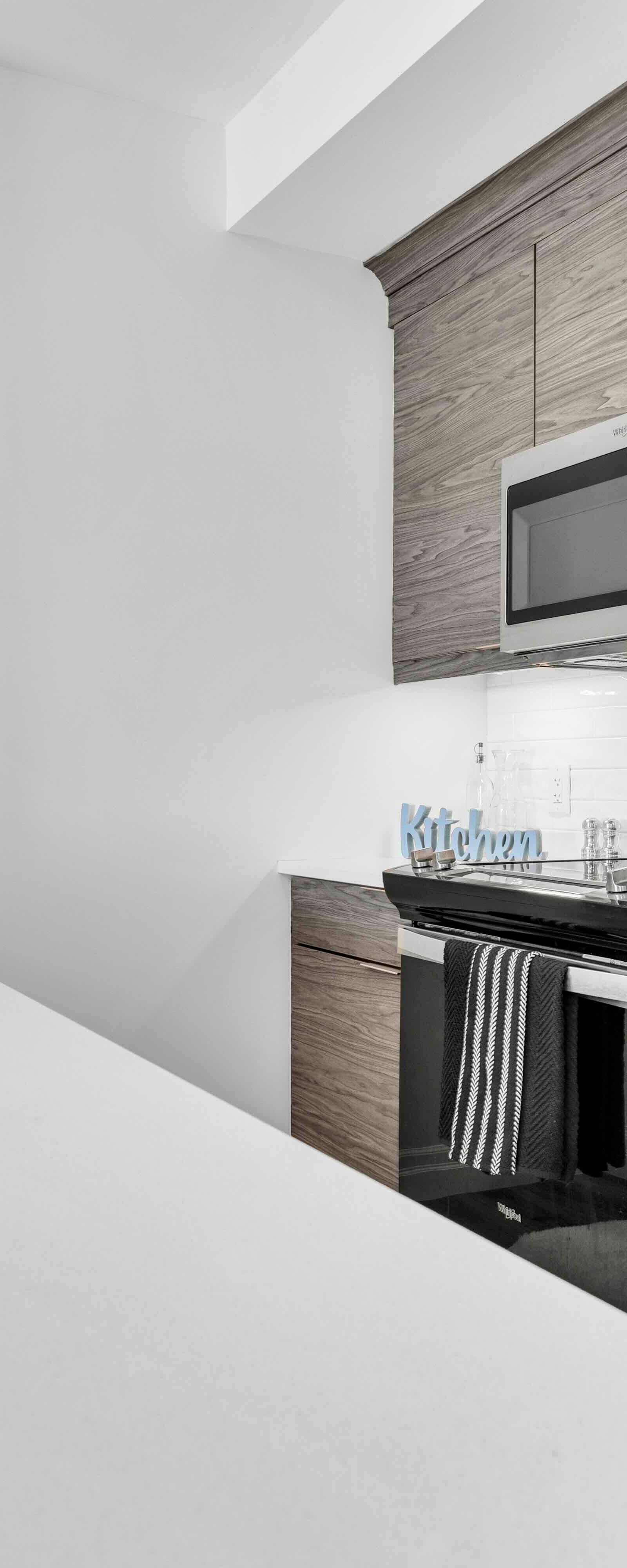 Kitchen countertop, sink, stove, and microwave close-up