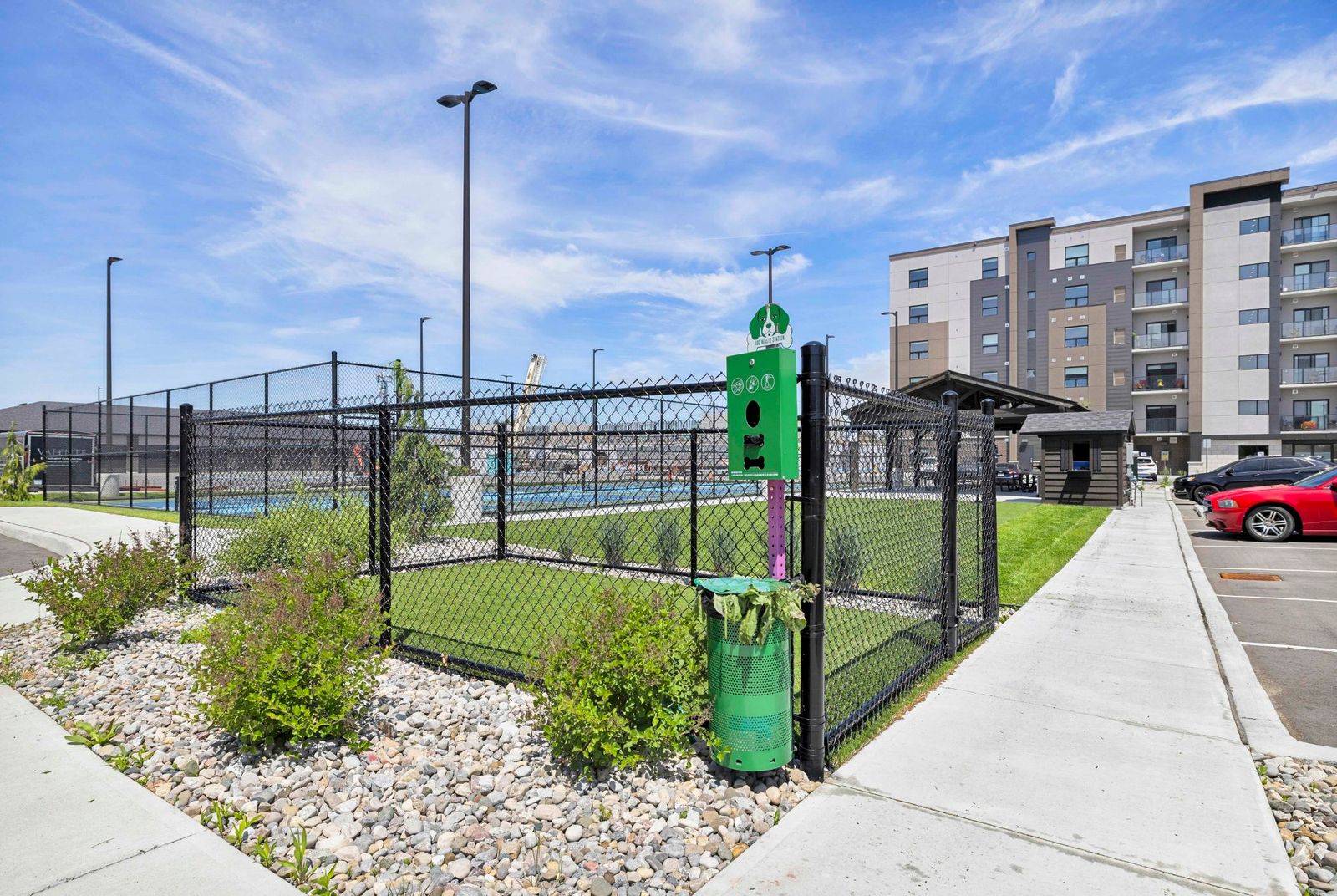 Pickleball courts with dog waste station and parking lot