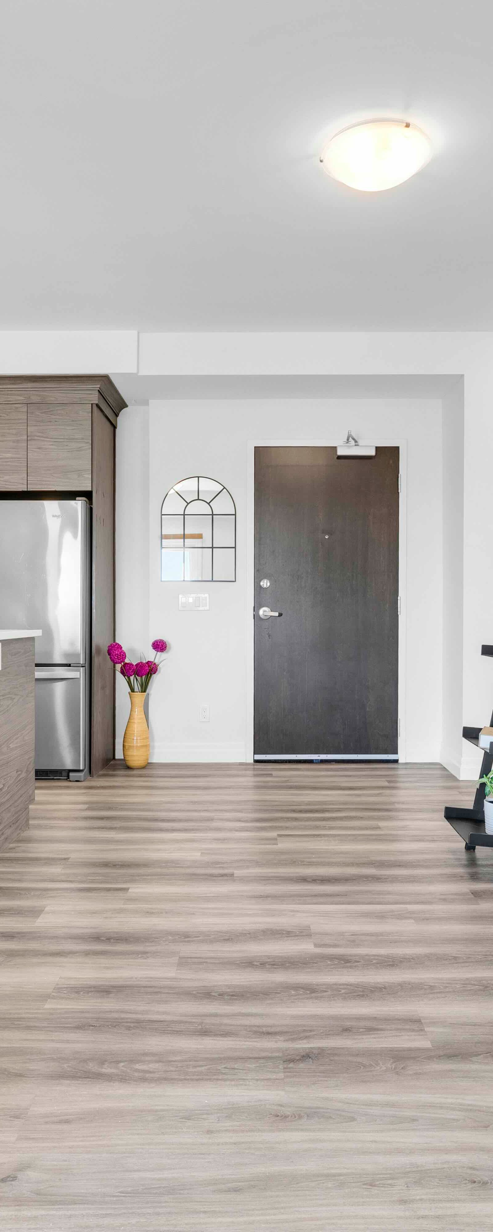 View from living area toward kitchen and main entrance