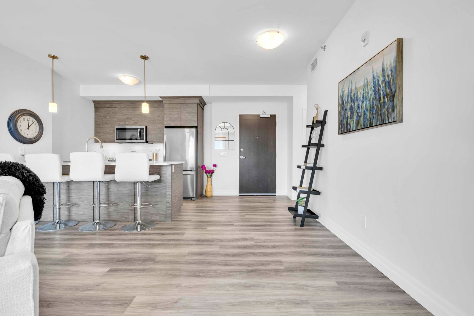 View from living area toward kitchen and main entrance