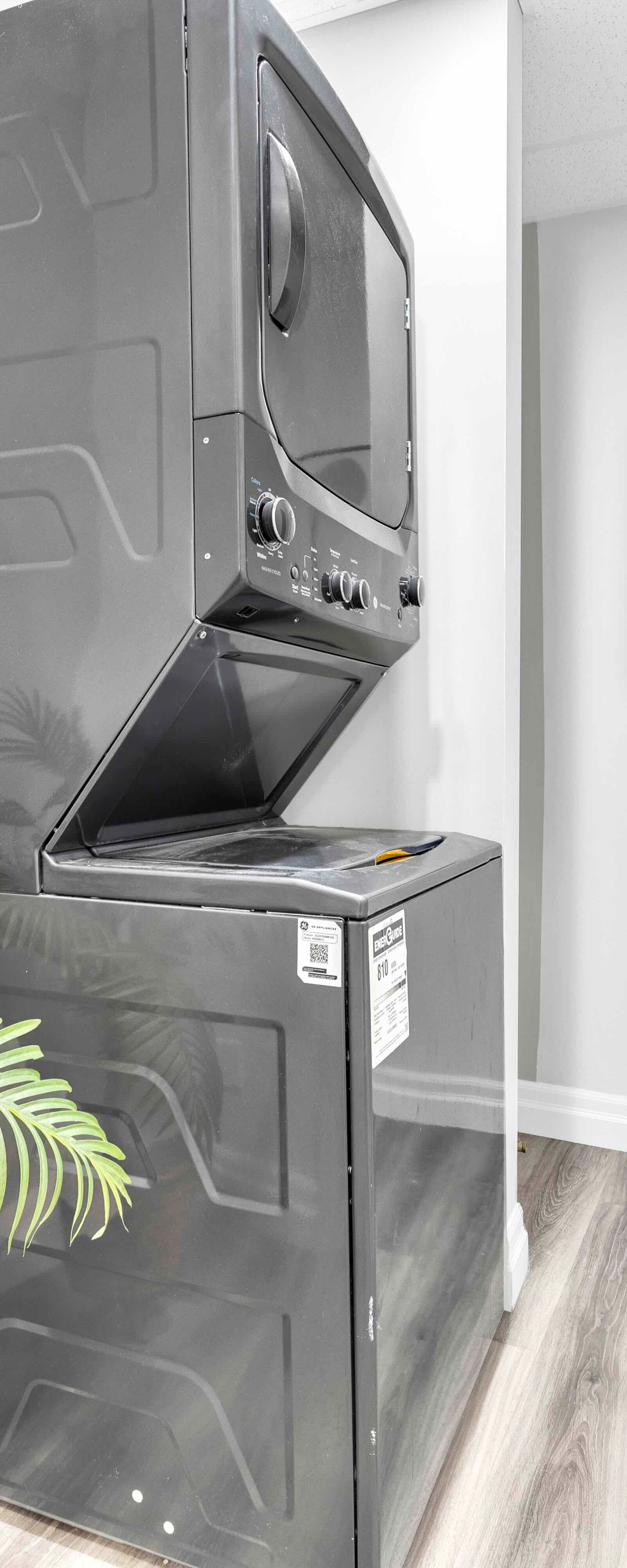 Laundry room with stacked washer and dryer