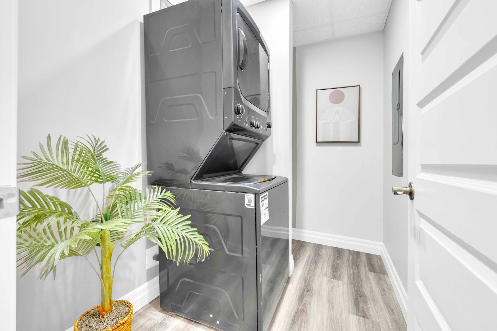 Laundry room with stacked washer and dryer