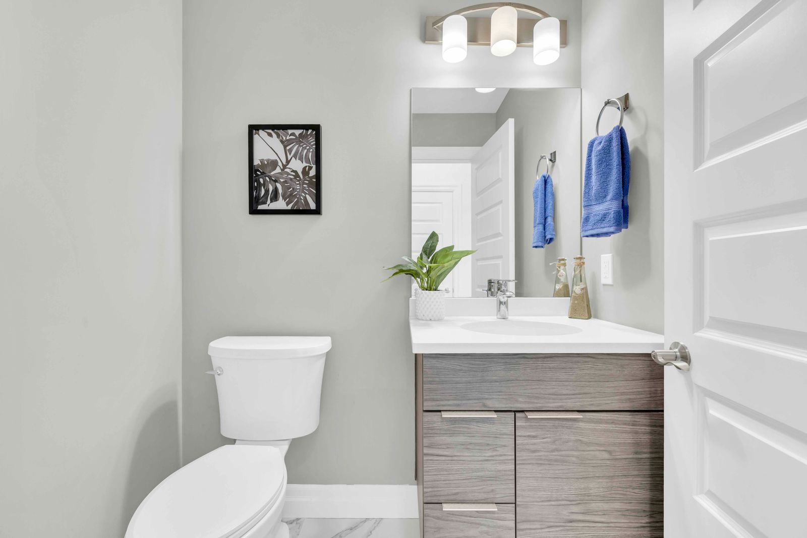 Second bathroom with toilet, vanity, and mirror