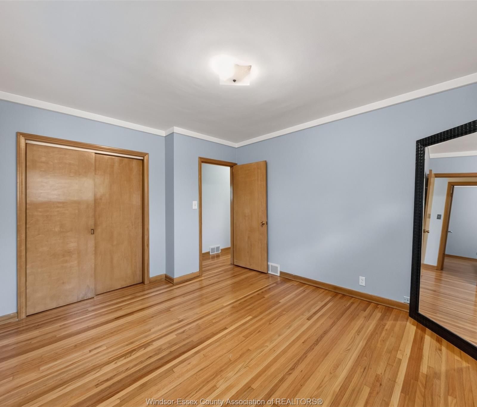 Bedroom with sliding wood closet doors