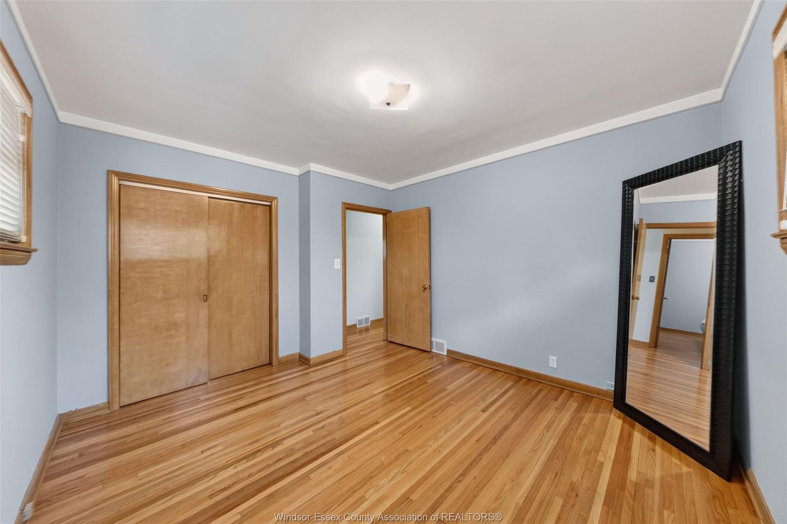 Bedroom with sliding wood closet doors