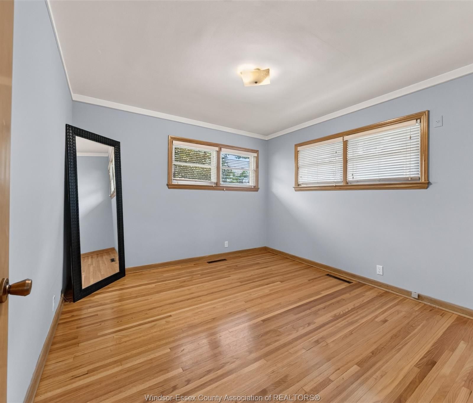 Bedroom with two large windows