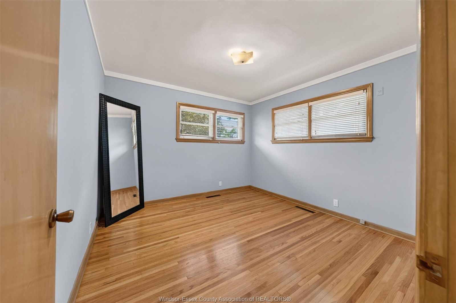 Bedroom with two large windows