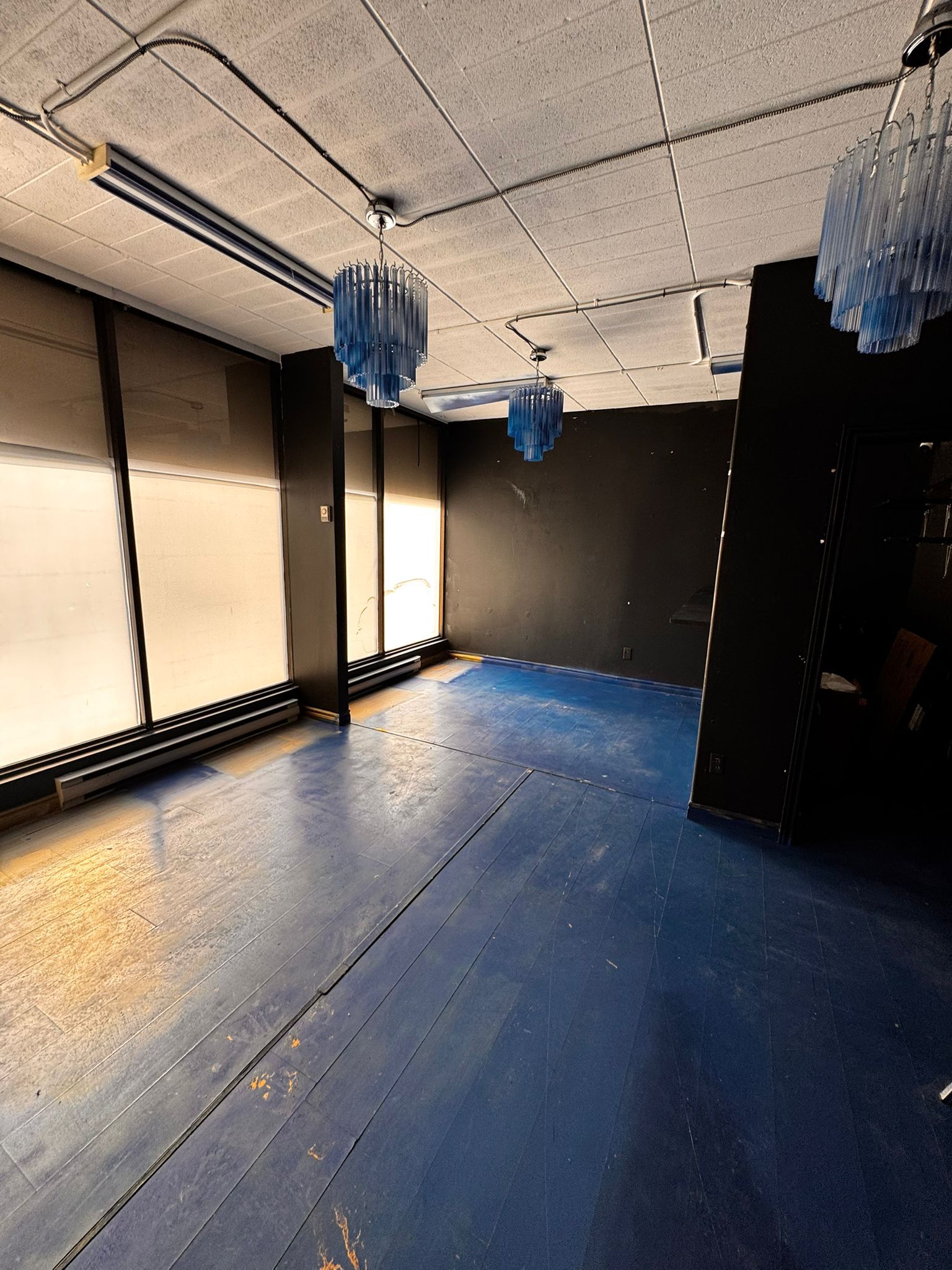 Large storefront windows with baseboard heaters below