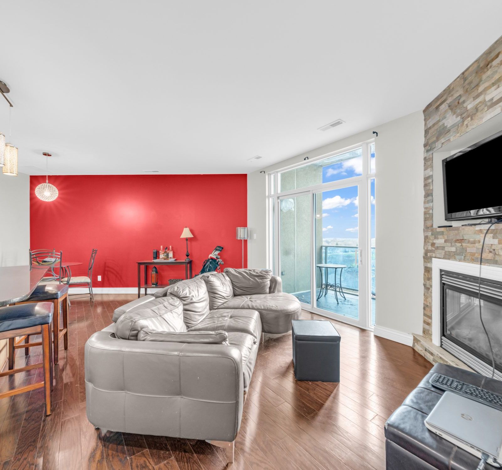 Living room with kitchen bar and dining area beyond