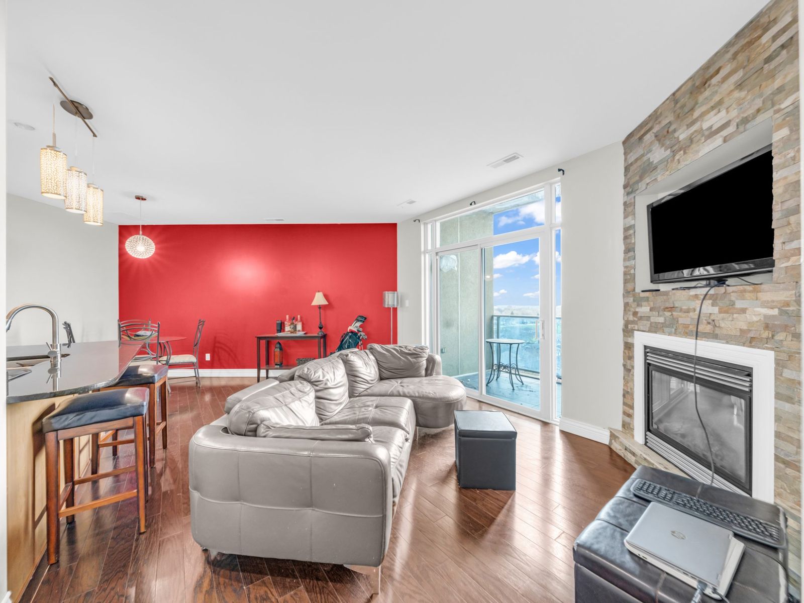 Living room with kitchen bar and dining area beyond