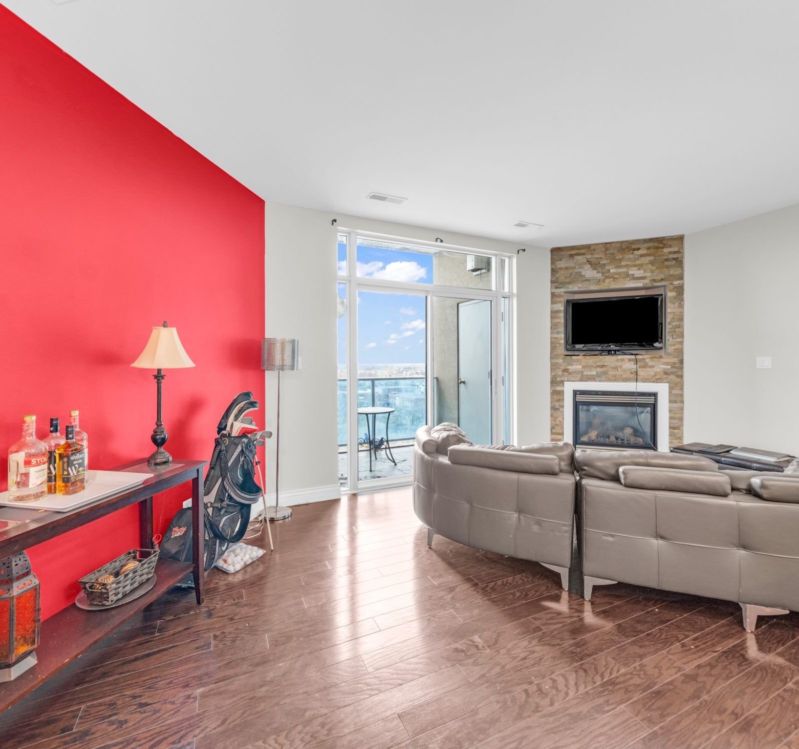 Living room red accent wall and balcony view