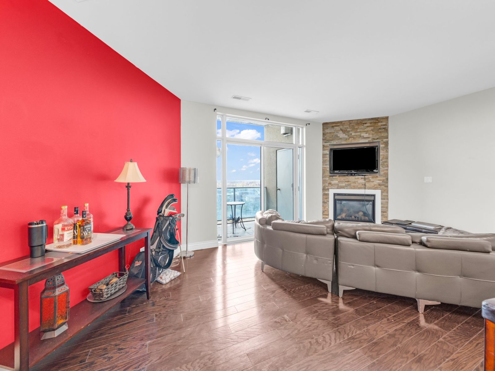 Living room red accent wall and balcony view