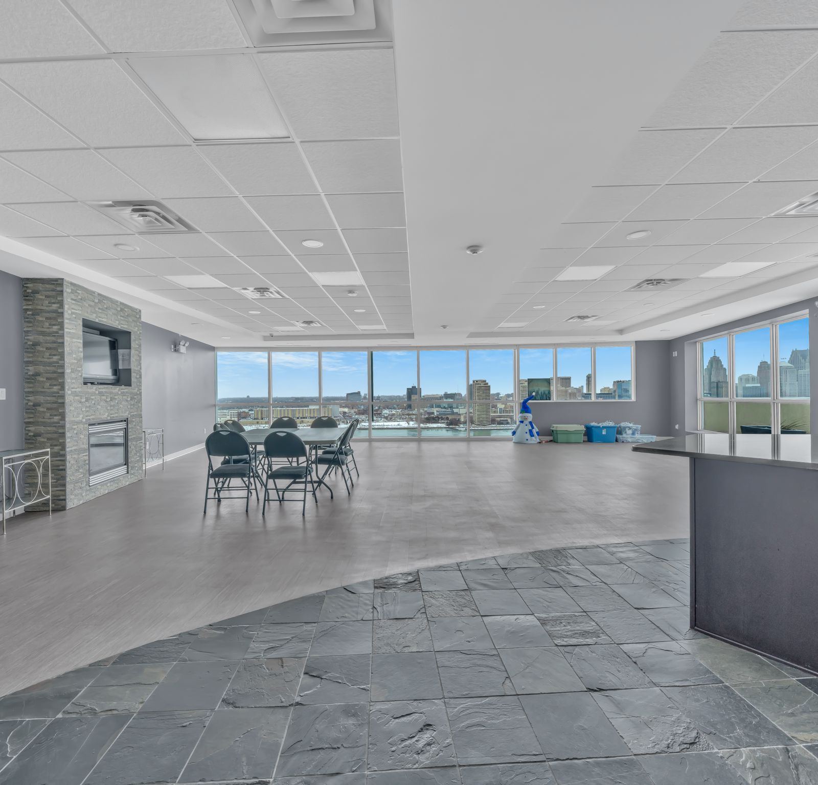 Party room with fireplace and panoramic city views