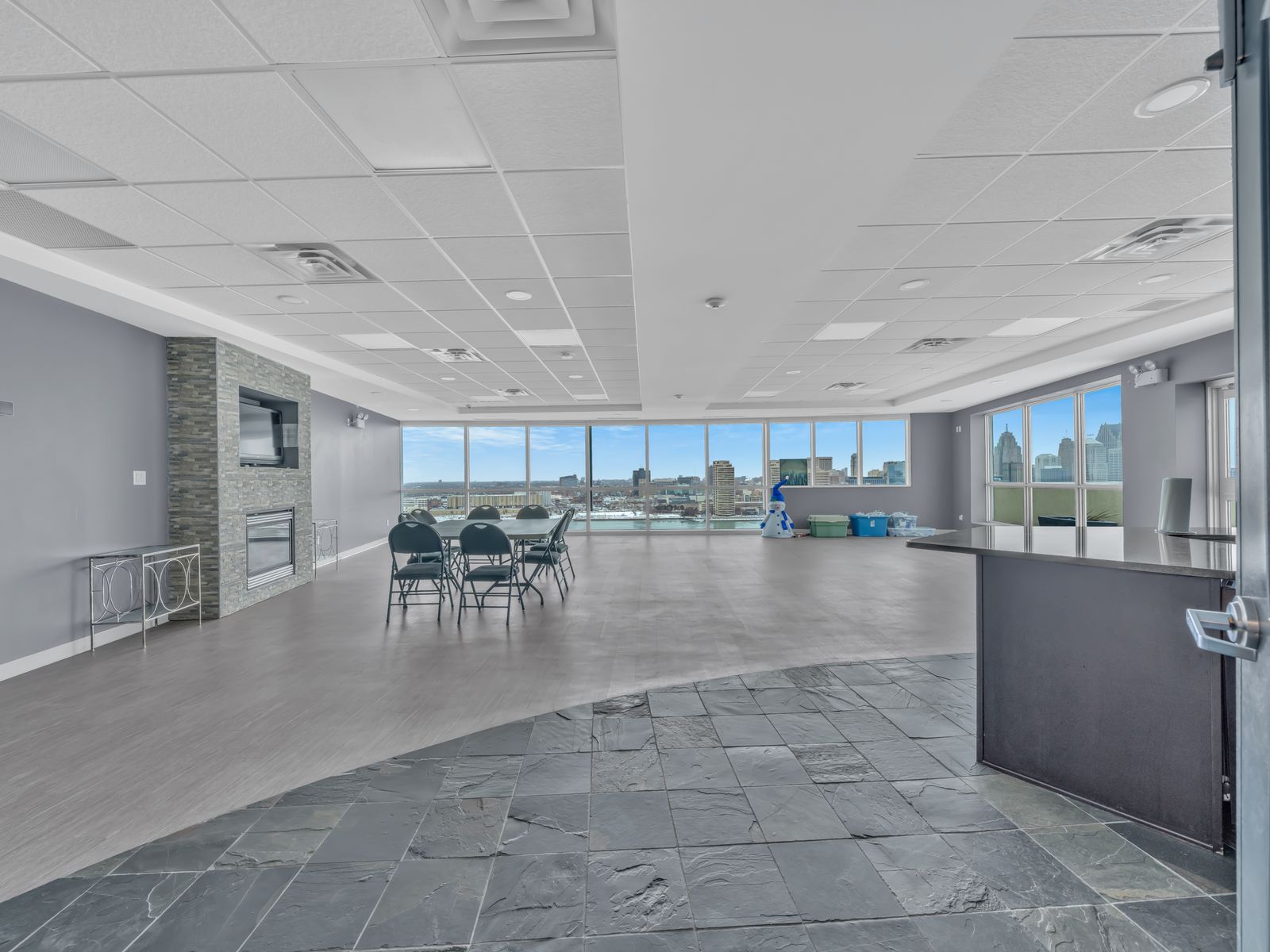 Party room with fireplace and panoramic city views