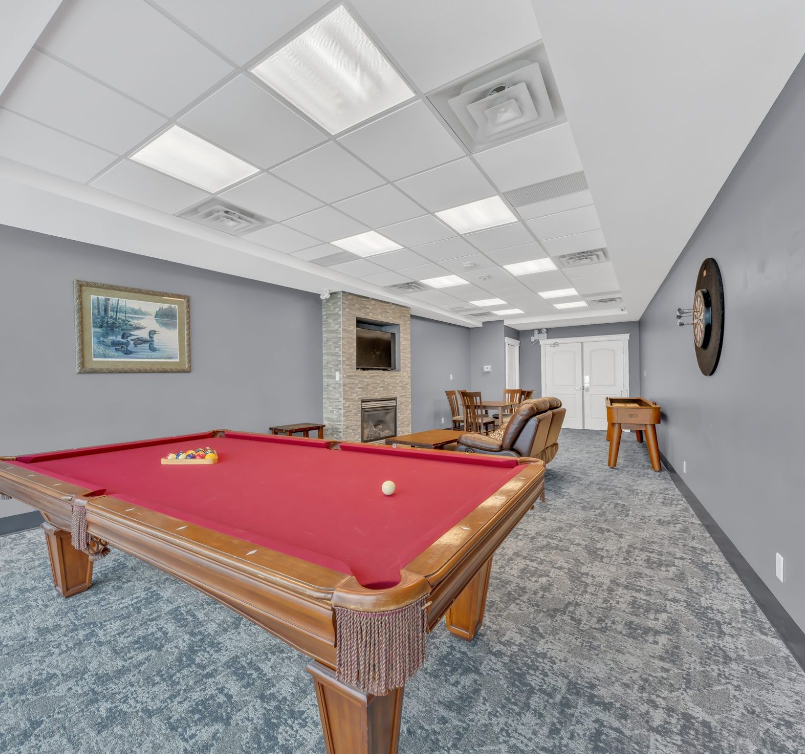 Games room — dartboard and fireplace