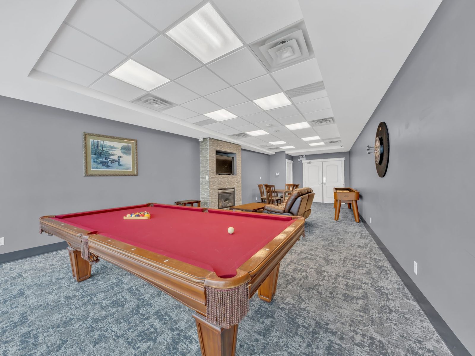 Games room — dartboard and fireplace
