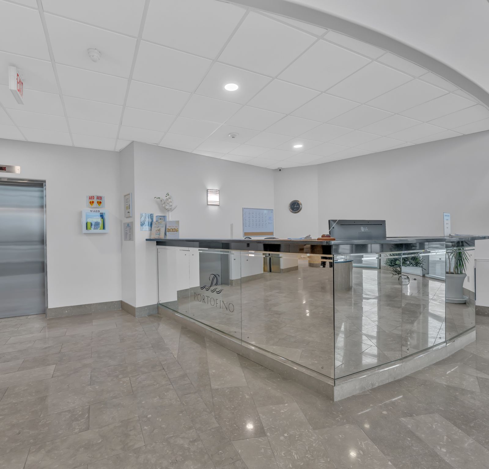 Concierge reception area with glass panels and elevator