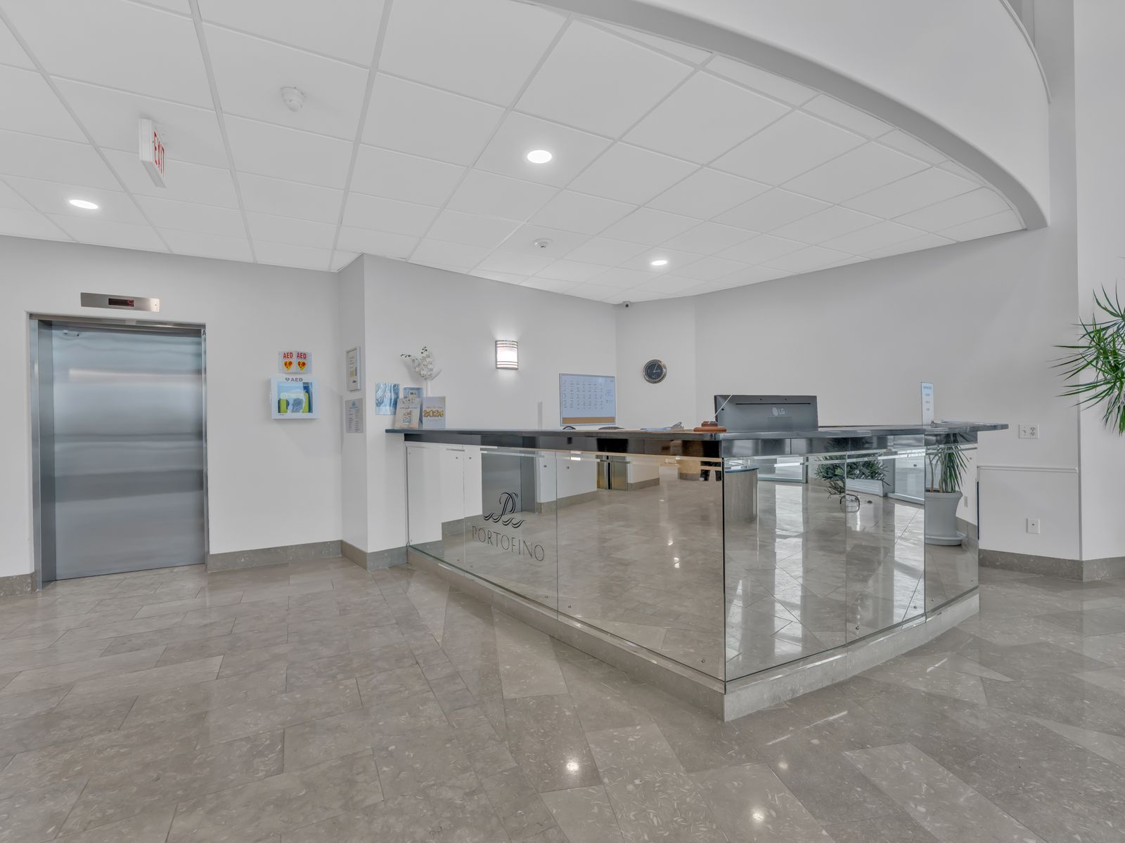 Concierge reception area with glass panels and elevator
