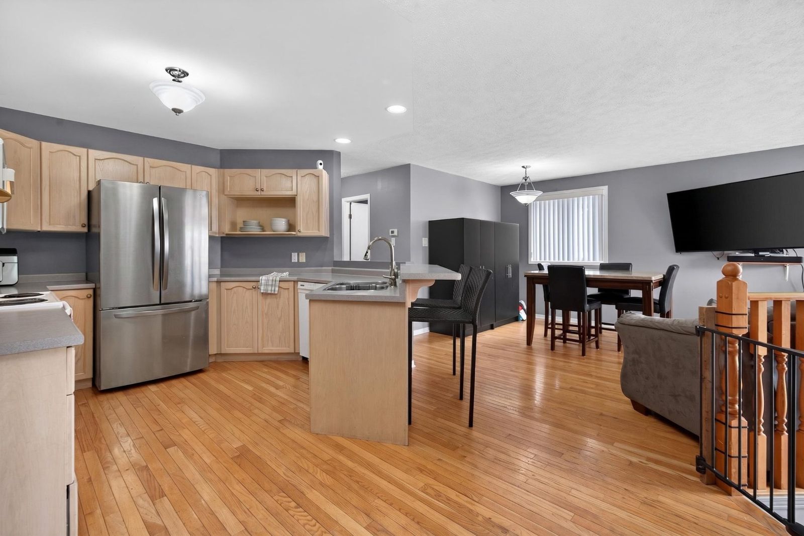 Open kitchen with breakfast bar extending into the living and dining area