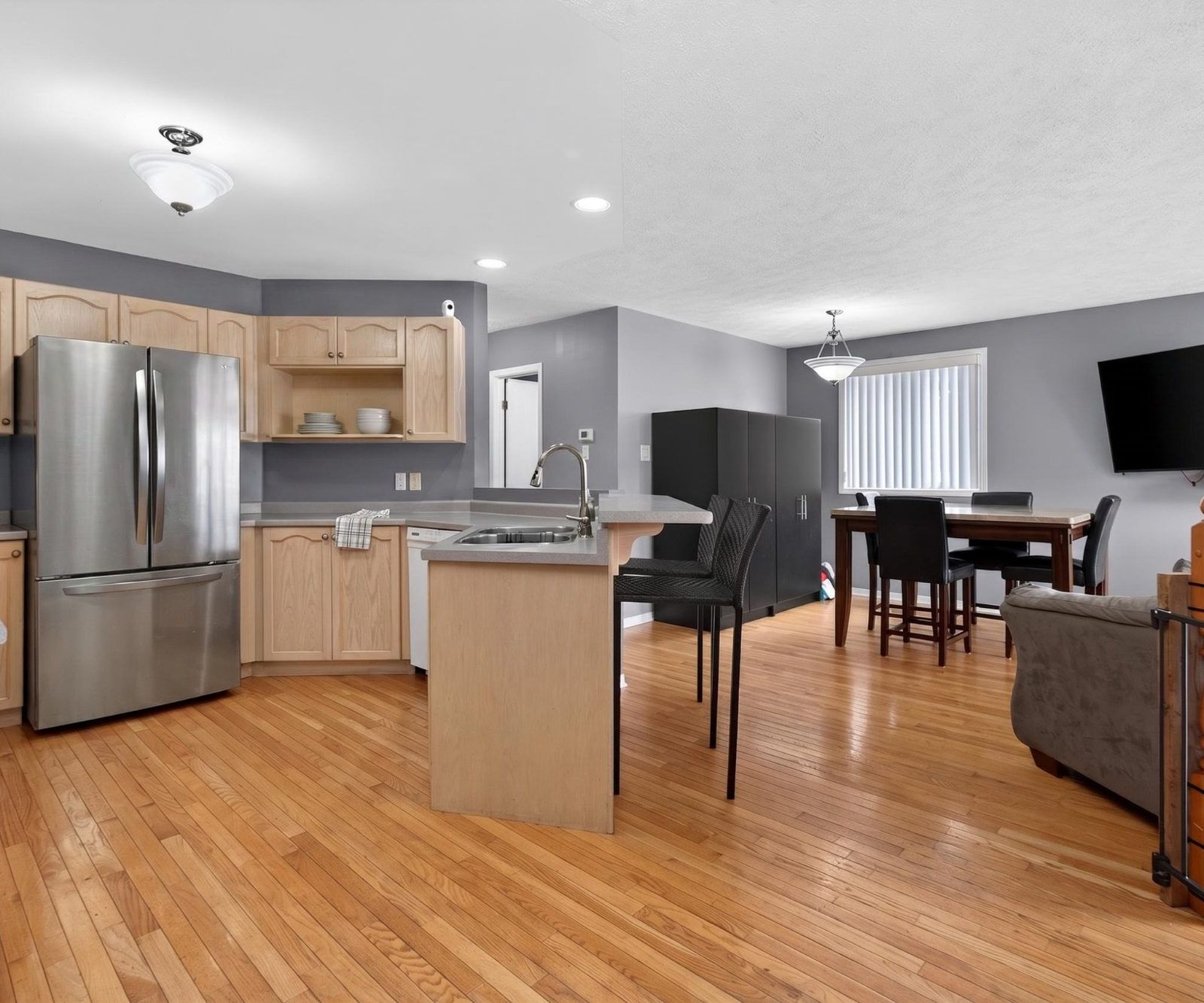 Open kitchen with breakfast bar extending into the living and dining area